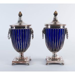 A pair of Sheffield plate lidded urns with Bristol blue glass…
