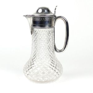 A silver plate and crystal claret jug, engraved top with domed…