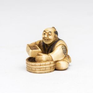 An ivory netsuke of a seated man with a barrel of rice and a…