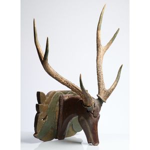 A rustic polychrome painted fruitwood and deer antler wall…