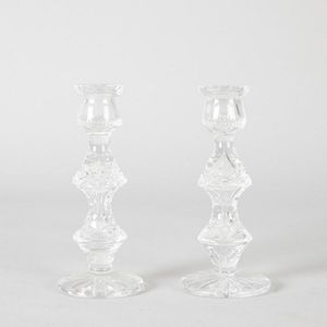 A pair of cut glass candlesticks, sunburst design to the base…