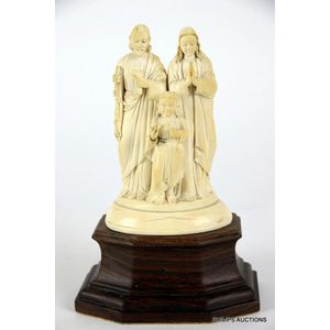 An antique ivory religious group of the holy family, 19th to…