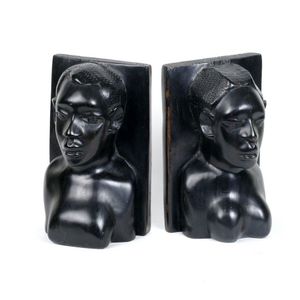 A pair of old African ebony bookends, the busts of tribal women.…