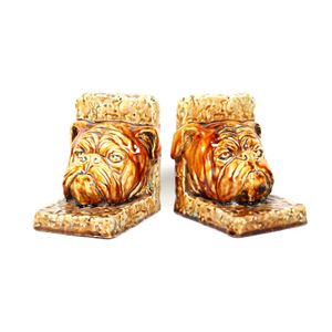 Christine a Pecket (1942) brown glazed book ends, in the form…