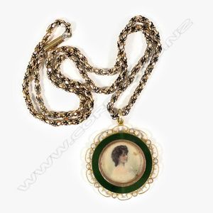A c.1900 yellow gold neck chain and photo locket, the glazed…