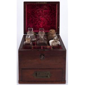 An antique mahogany apothecary box with red velvet compatment…