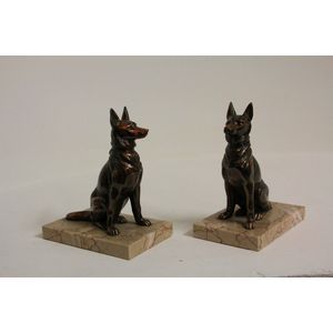 A pair of French Art Deco metal dog figured book ends on…