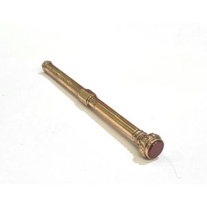 A gold lined, carnelian seal top propelling pencil, engraved…