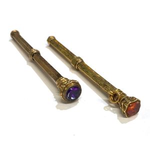 Two gold lined, purple & orange glass seal top propelling…