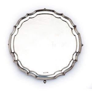 A Queen Anne style sterling-silver shaped circular salver,…