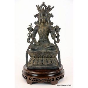A Tibetan bronze crowned white Tara and a rosewood display&hellip;