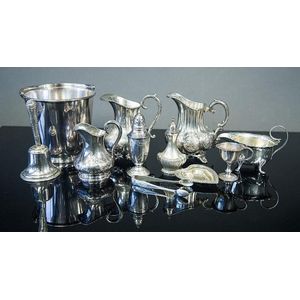 11 various silverplated table items, including ice bucket;…
