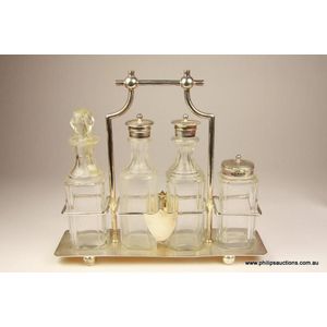 A Victorian cruet set with a silver plated stand, the four…