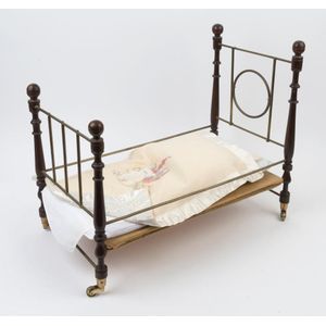 A dolls miniature bed with bedding, 20th century, 49 cm high,…
