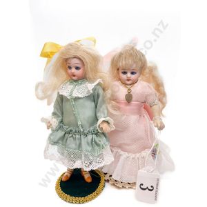 Two small bisque dolls, blue sleeping eyes closed mouths,…