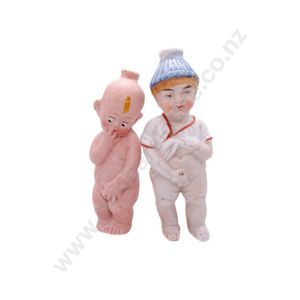 Two all bisque character 'Pissing' dolls, moulded and painted…