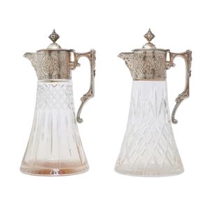A matched pair of silver plate mounted cut crystal claret jugs,…
