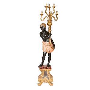 A 20th century polychrome and gilded blackamoor standing…