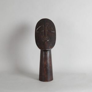 A modernist carving, depicting a large bust made from wood.…