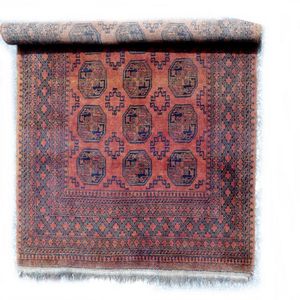 A large hand knotted Afghan Bokhara rug, the field with three…