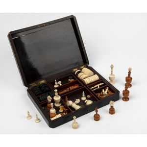 An antique French games box with game pieces for chess and…
