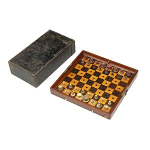 An antique travelling chess set with carved ivory pieces and…