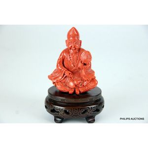 A salmon coral figure of a seated man, the coral with natural&hellip;