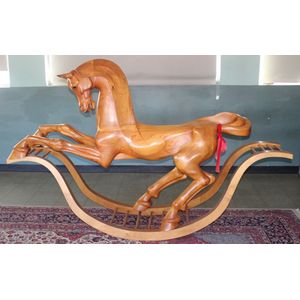 A life size fine carved pine rocking horse, initialled K.W.B…