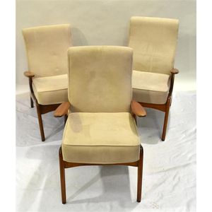 A three blonde oak Parker style armchairs in cream upholstery