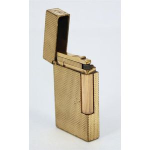 A S.T. Dupont lighter, guilloche design, gold plated. 6.3 x 3.8…