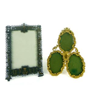 An Egyptian revival metal photograph frame and another gilt…