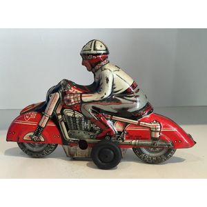 A tin racing motorcyclist friction toy by Huki-Keinberger, made…