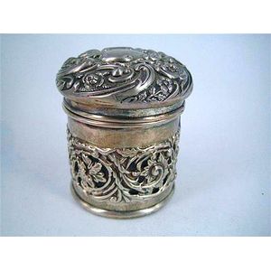 A late-Victorian silver dressing-table jar with pierced foliate…