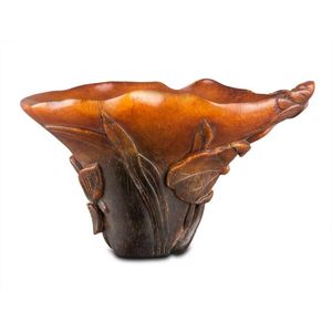 A small rhino horn cup, late Qing dynasty carved with a lotus…