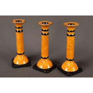 Three Italian porcelain candlesticks, in faux sienna marble…