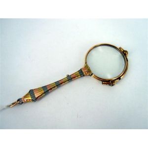 A gilt-metal Lorgnette with three-colour engine-turned stem.