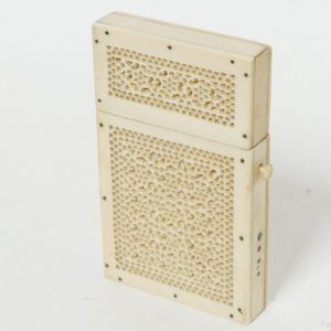 A small finely carved ivory card case, the exterior profusely…