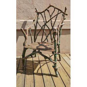 A rustic armchair, formed of natural hardwood boughs with an…