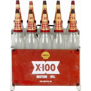 Shell X-100 oil rack with 10 quart bottles and tin tops with…