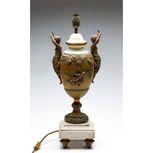 An urn form metal and marble table lamp featuring twin caryatid…