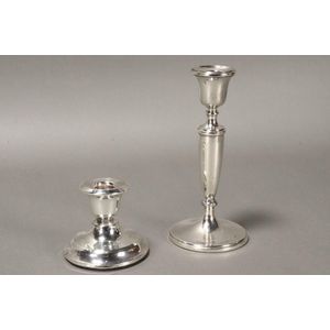 Two English sterling silver candlesticks, one of elongated form,…
