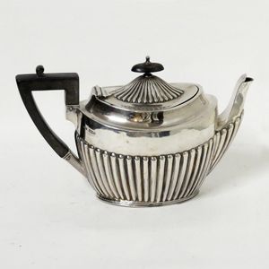 A Georgian Revival teapot, oval with half lobed body. Sheffield…