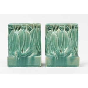 A pair of Melrose pottery bookends, each modelled as a cluster…