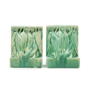 A pair of Melrose pottery bookends, each modelled as a cluster…