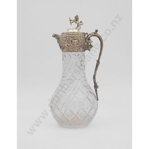A cut crystal claret jug, with silverplate mount, hinged lid…