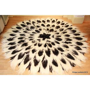 A Colobus monkey pelt rug, circular, formed of seventy-two…