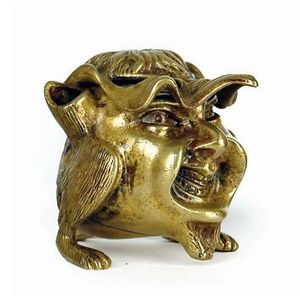 A Victorian brass inkwell, in the form of a grotesque devil…