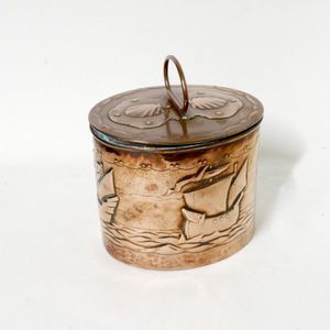 An Arts & Crafts copper tea caddy, the exterior decorated with…