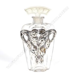 An early 1900s French glass perfume bottle, silver overlay…