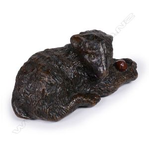 A late Georgian papier-mache snuff box, in the shape of a dog…